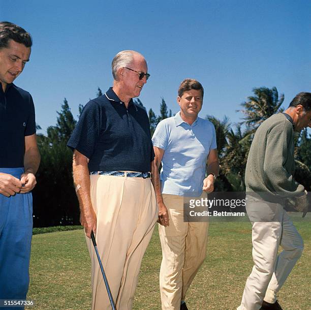West Palm Beach, Florida: President F. Kennedy is shown on the golf course with Peter Lawford, right, Stephen Smith, left, and his father, Joseph P....