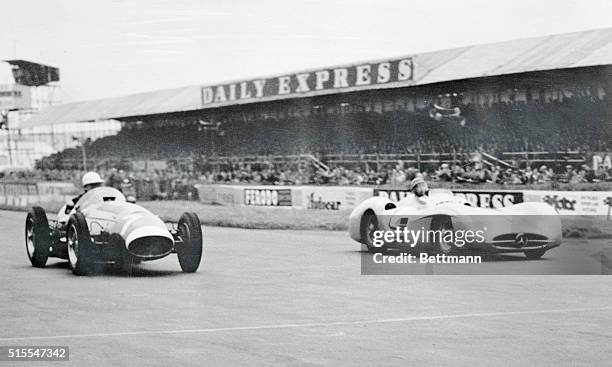 Fangio, of Argentina, in a Mercedes-Benz, and Stirling Moss, fight for position during the grand prix race at Silverstone last Saturday. The race was...