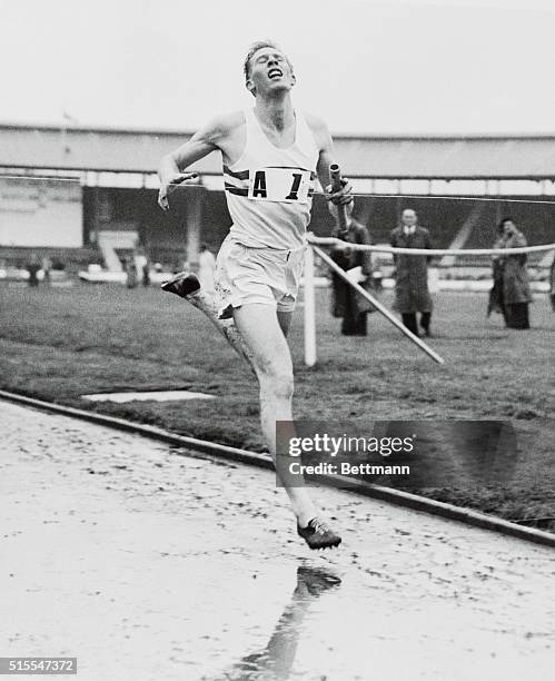 Roger Bannister, the first athlete to complete a less than four minute mile, runs strongly to finish and win the last lap of the 4x1500 meter relay...