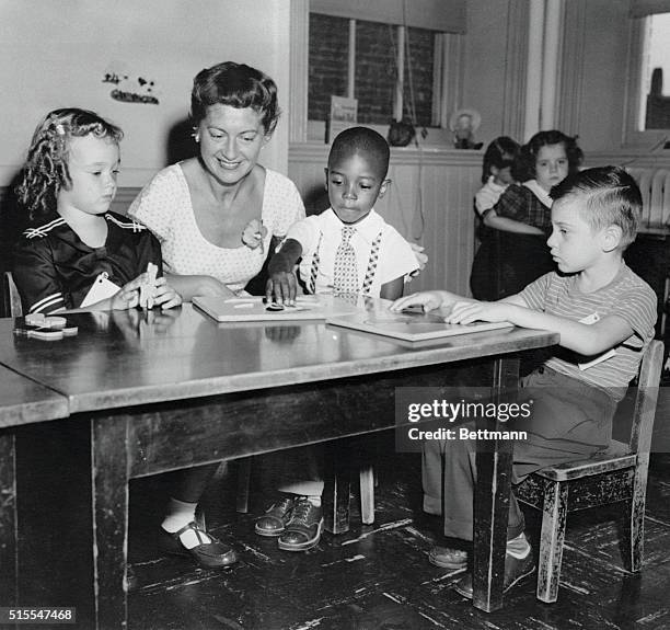 For the first time in the city's history, black and white children are sharing class work and playgrounds at a dozen or more schools in Baltimore....