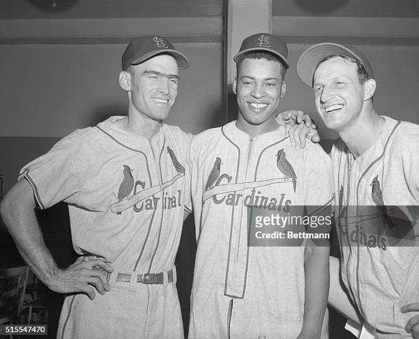 Celebrating their 7-4 win over the giants are Cardinals : Wally Moon, who belted a bases empty Homer; winning pitcher Brooks Lawrence, and Stan...