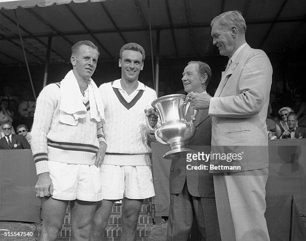 Col. James Bishop, President of the U.S. Lawn Tennis Association present Vic Seixas with the winning trophy after he eliminated Rex Hartwig of...