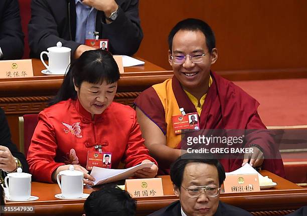 The Chinese government-selected 11th Panchen Lama Gyaincain Norbu sits with other delegates during the closing session of the Chinese People's...