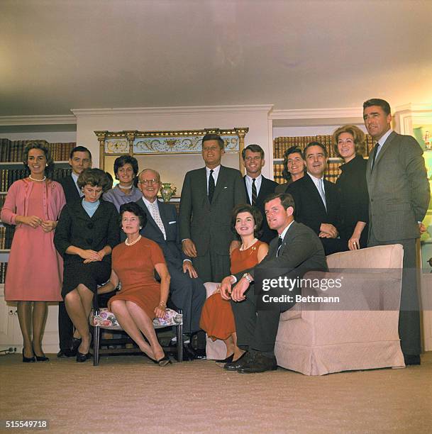 President-elect John F. Kennedy and members of his family pose in the living room of his father's home here Nov. 9th. Seated are his sister Mrs. R....