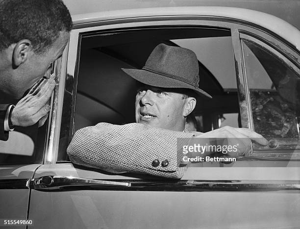 Prince Aly Khan, ex-husband of Rita Hayworth Haymes, talks to a reporter in his car shortly after his arrival today at Idlewild Airport. The Muslim...