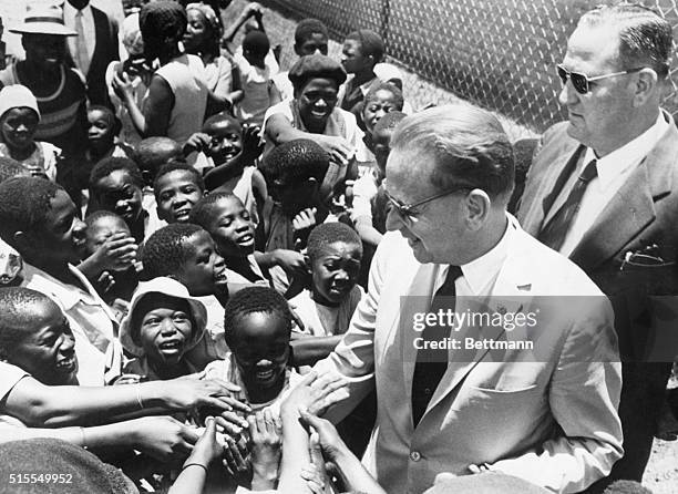 Ridgeville, South Africa- Eager to shake hands, smiling Negro children cluster around visiting United Nations Secretary-General Dag Hammarskjold...