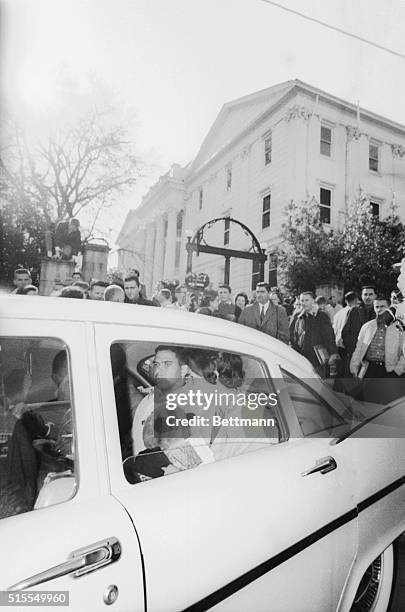 African American students Charlayne Hunter and Hamilton Holmes leave the campus of the University of Georgia after they registered for classes,...