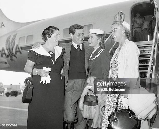 Debbie Reynolds and her mother flew into New York and were greeted at Idlewild Airport by singer Eddie Fisher and his mother, which seemed to lend...