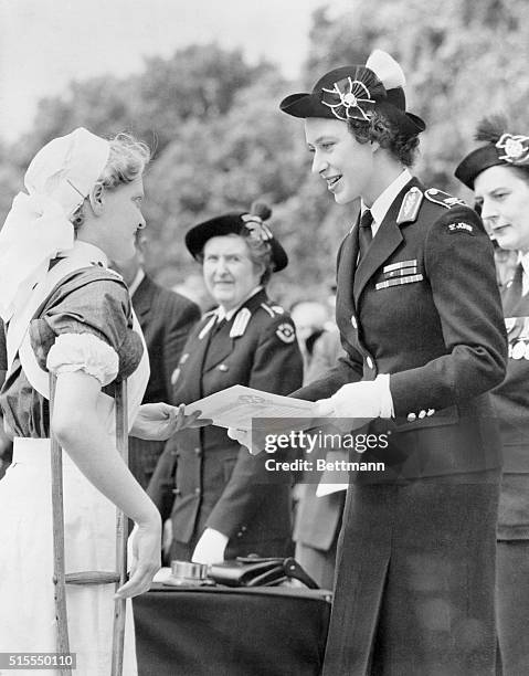 Princess Margaret, in uniform of an officer in the St. John's ambulance brigade, is shown as she presented an award to Cadet Barbara Goodyear during...