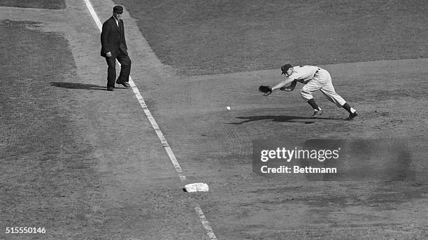 Al Rosen of the Cleveland Indians is doing a mighty stretch in an attempt to reach the ball as Wes Westrum slashed a bounding single into the left...