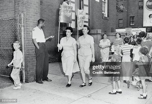 Baltimore youngsters look on as parents picket a school yesterday in south west Baltimore in the City's first expression of protest against the end...