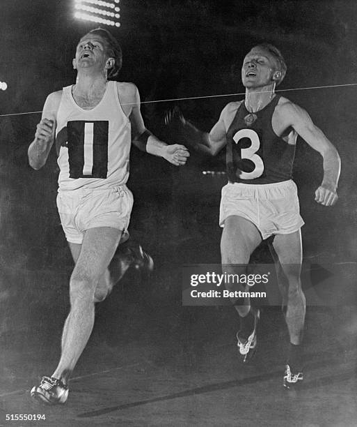 Chris Chataway, left, is shown beating V. Kuts of Moscow in the 5,000 meter event at the London vs Moscow athletic meet at White City. Chataway's...