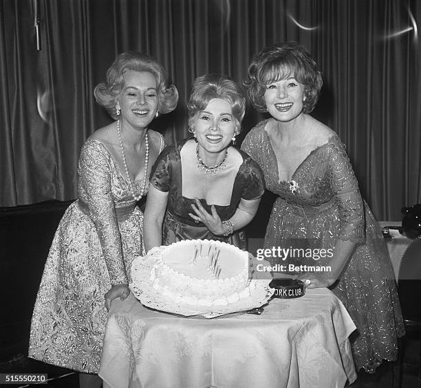 'Tis a Question. New York, New York: Celebrating her "?" birthday, Zsa Zsa Gabor is flanked by sisters, Eva and Magda during a party at the Stork...