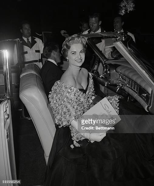 Hollywood glamour girl Martha Hyer came close to stealing the spotlight at the World Premiere at the Hollywood Paramount theatre last night of...