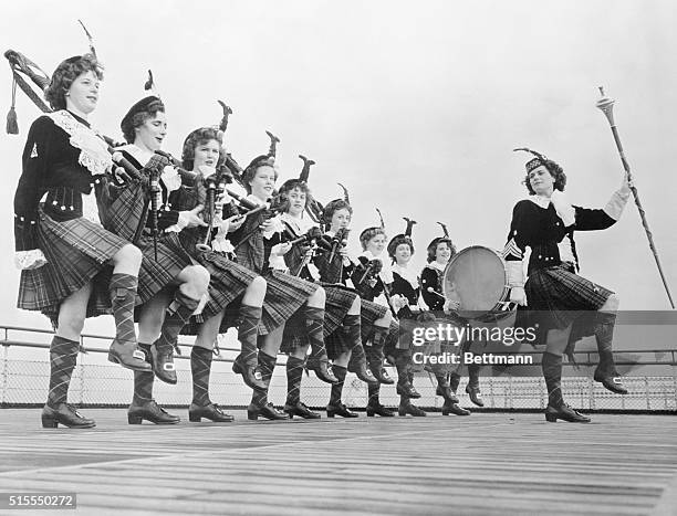 Picturesque arrivals on the S.S. Queen Elizabeth today were these bekilted musicians of the Dagenham Girl Pipers Band, of Dagenham, Eng. They are...