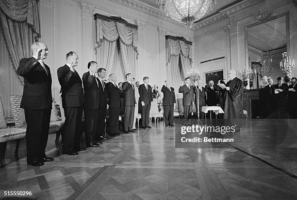 Swears In New Cabinet. Washington, DC: Chief Justice Earl Warren swears in new Kennedy Cabinet in White House ceremony, January 21st. Left to right...