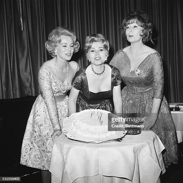 'Tis a Question. New York, New York: Celebrating her "?" birthday, Zsa Zsa Gabor is flanked by sisters, Eva and Magda during a party at the Stork...