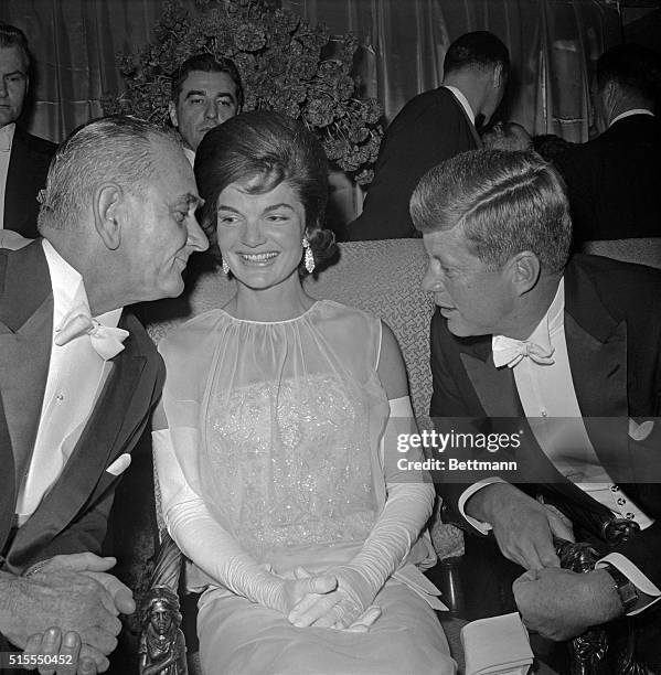 Vice President Lyndon B. Johnson chats with the President and Mrs. Kennedy at the inaugural ball in the Mayflower Hotel, January 20th. Mrs. Kennedy's...