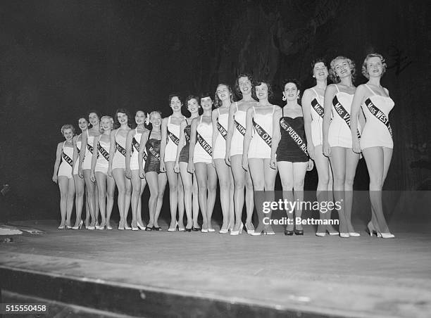 Lined up for the judges in the first day's judging of swimsuits are seventeen hopefuls vying for the Miss American 1955 crown. Winner of the gold cup...