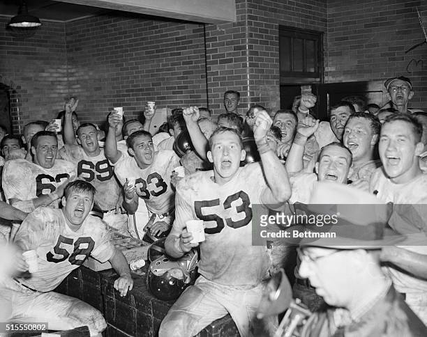 The victorious Purdue Boilermakers are shown celebrating in their dressing room after scoring the upset of the week by defeating Notre Dame 27 to 14...