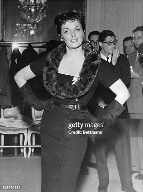 Here's curvaceous Jane Russell after fearlessly entering the Dior fashion den and being fitted with one of his "flat-look" creations. Miss Russell's...