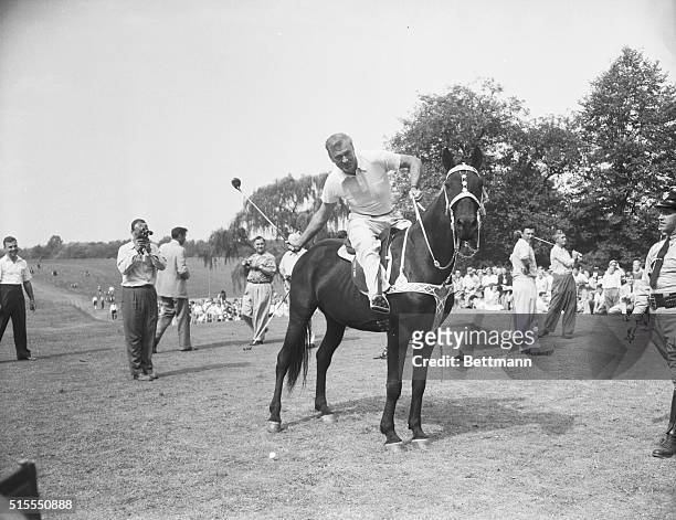 Film star Gary Copper on horseback, tees off on the first hole at the National celebrities golf tourney being held at the Congressional Country Club.