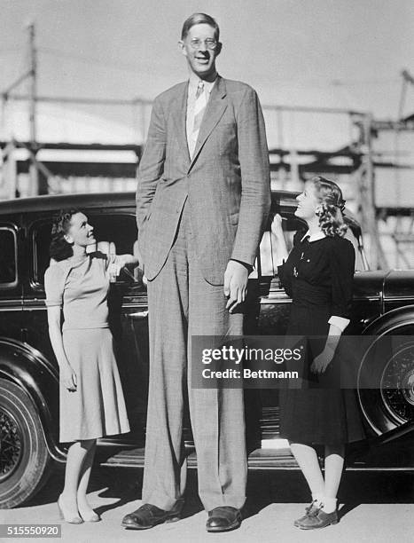 Actresses Maureen O'Sullivan and Ann Morris stand next to giant Robert Wadlow. Wadlow was eight feet, eight and one half inches tall at the time this...