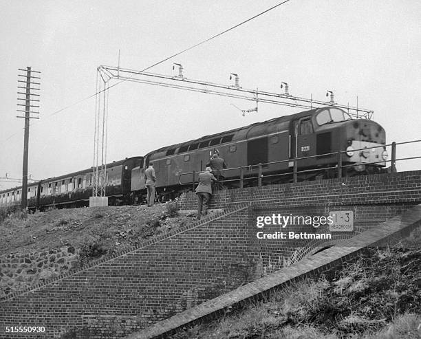 British express train speeds past the spot where bandits stopped and hijacked the Aberdeen Express, a travelling post office bound from Glasgow to...