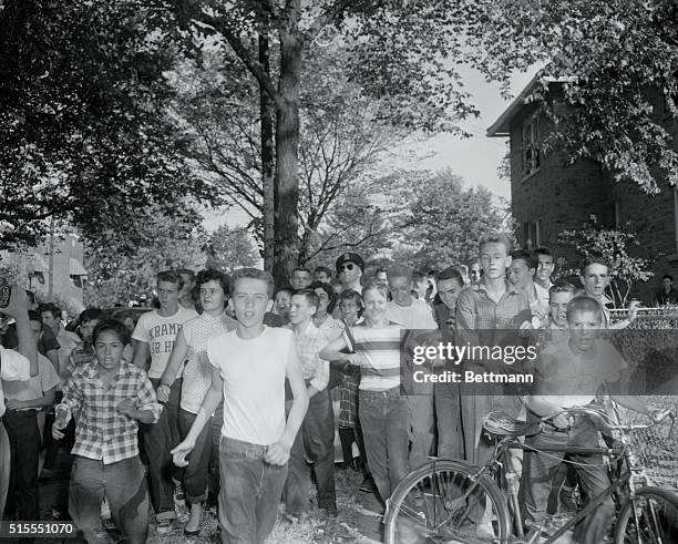 Students of the Anacostia High School are shown running after some Negro school children as a local schools today in protest against the end of...