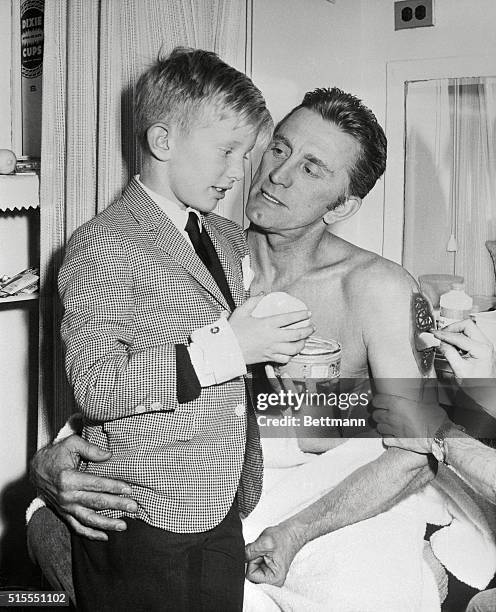 Eight year old Peter Vincent Douglas gets a few pointers on acting from his father, Kirk Douglas, as Peter visits backstage at the Cort Theater, here...