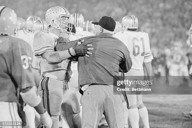 Jacksonville, Fla.: Ohio State head football coach Woody Hayes takes a punch at one of his own players Ken Fritz and offensive guard who is trying to...