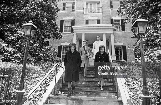 Jacqueline Kennedy and her sister Lee Radziwill are shown leaving the new Georgetown home, here 12/18, which Mrs. Kennedy recently purchased. The...