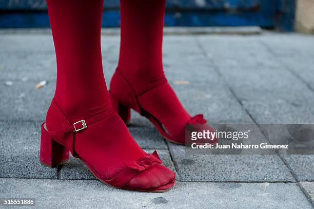 Ela wears Zendra shoes, Calzedonia stockings, Brigitte Bardot sunglasses and vintage handbag, hat and coat on March 14, 2016 in Madrid, Spain.