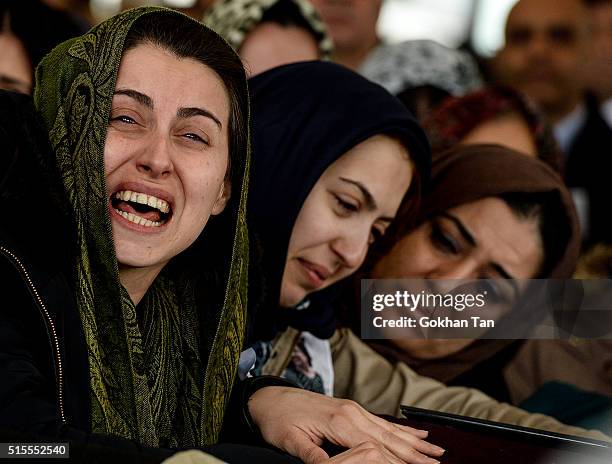 Family members and relatives of car bombing victim Hamide Sibel Cetinkaya, mourn over a coffin during the funeral ceremony in a mosque on March 14,...