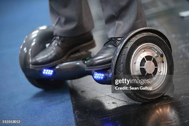 Host rides a BykeBoard hoverboard at the 2016 CeBIT digital technology trade fair on the fair's opening day on March 14, 2016 in Hanover, Germany....