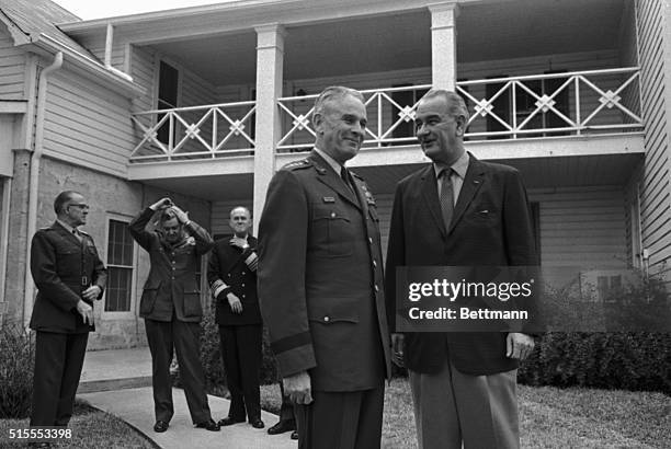 President Johnson looking his chipper self again today pins a Distinguished Service medal on General Curtis E. LeMay, retiring Air Force Chief of...