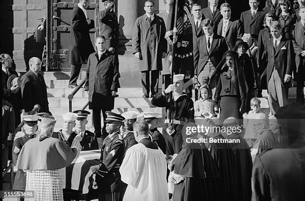 Archbishop Richard Cushing blesses the coffin containing the remains of President John F. Kennedy outside St. Matthew's Cathedral.