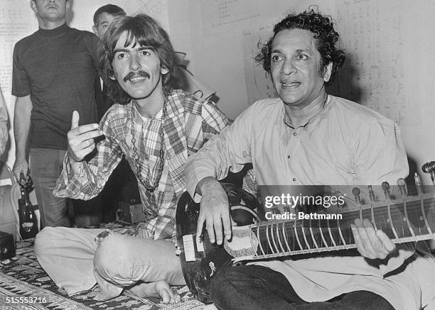 Hollywood: Beatle George Harrison, , listens as Ravi Shanker of India plays the sitar, 8/3, a 25-stringed guitar-like instrument. Harrison said he is...