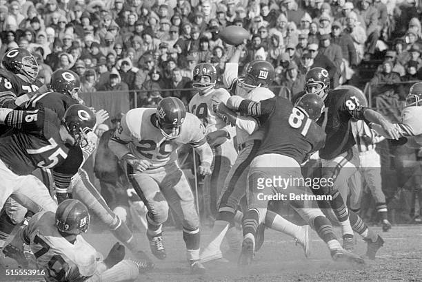 New York Giants' quarterback Glynn Griffing a replacement for injured Y.A. Tittle, gets tackled by Chicago Bears' Doug Atkins (81 as he attempts to...