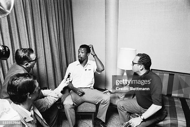 Suspended American Olympic star John Carlos scratches his head as he tells newsmen 10/19 that he'll leave Mexico 10/21 to return to school at San...