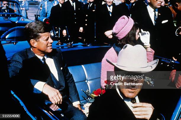 President John F Kennedy , First Lady Jacqueline Kennedy , and Texas Governor John Connally ride in a motorcade from the Dallas airport into the city.