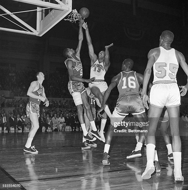 The battle of the giants is on as Boston Celtics' Bill Russell and San Francisco Warriors' Wilt Chamberlain, centers of their respective teams, go...
