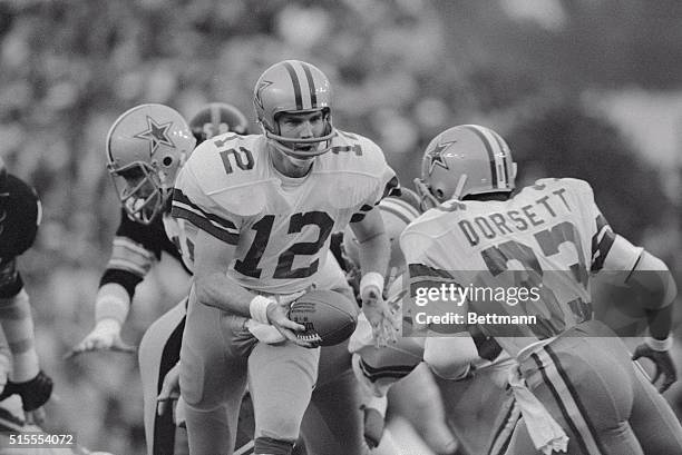 Cowboys quarterback Roger Staubach hands off to running Tony Dorsett in the first quarter of Super Bowl XIII, Cowboys vs. Steelers.