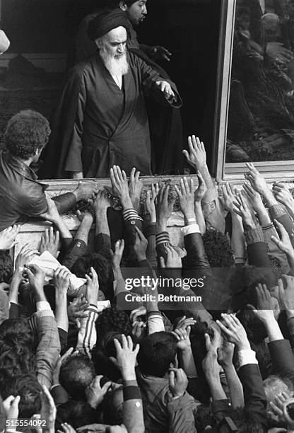 People crowd around to try and shake hands with or touch Ayatollah Ruhollah Khomieni in Tehran February 3, 1979. He had returned from exiled February...