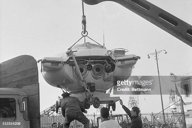 The French diving saucer built by scientist commandant Jacques Cousteau, looks like a monster as it is lifted from the Cousteau ship "Calypso" to a...