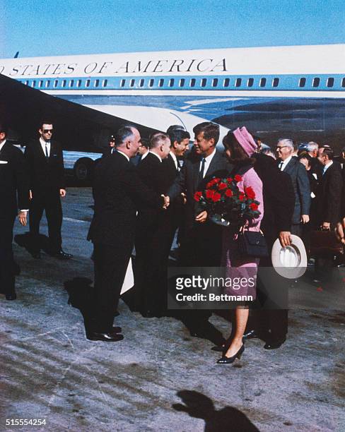 President John F Kennedy, First Lady Jacqueline Kennedy, carrying a bouquet of red roses, move down reception line, November 22nd, shortly after...