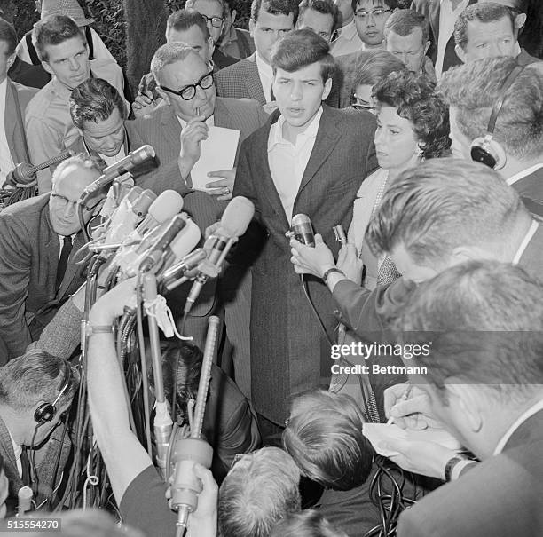 West Lost Angeles: Frank Sinatra Jr. With his mother, Nancy, on his left, meets the press in front of his mother's home after being released here...