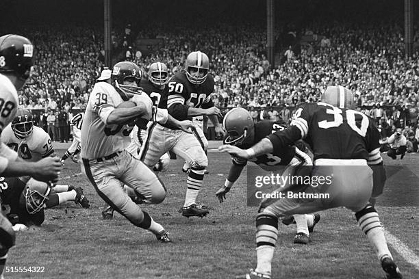 Hugh McElhenny , halfback of New York Giants carries ball for first down in third quarter action against the Cleveland Browns. Larry Benz and Vince...