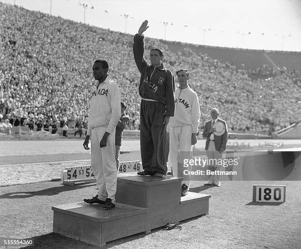 Three winners of the Olympic 1,500 meter event, turn to the peristyle in Olympic Stadium where the flags of their country fly signifying their...