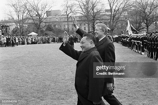 Washington, DC- Chinese Vice Premier, Teng Hsiao-ping, and President Carter wave to the crowd gathered on the south lawn of the White House to...